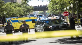 Emergency services personnel respond to the scene outside Gregory Gym where four students were stabbed, one fatally. 