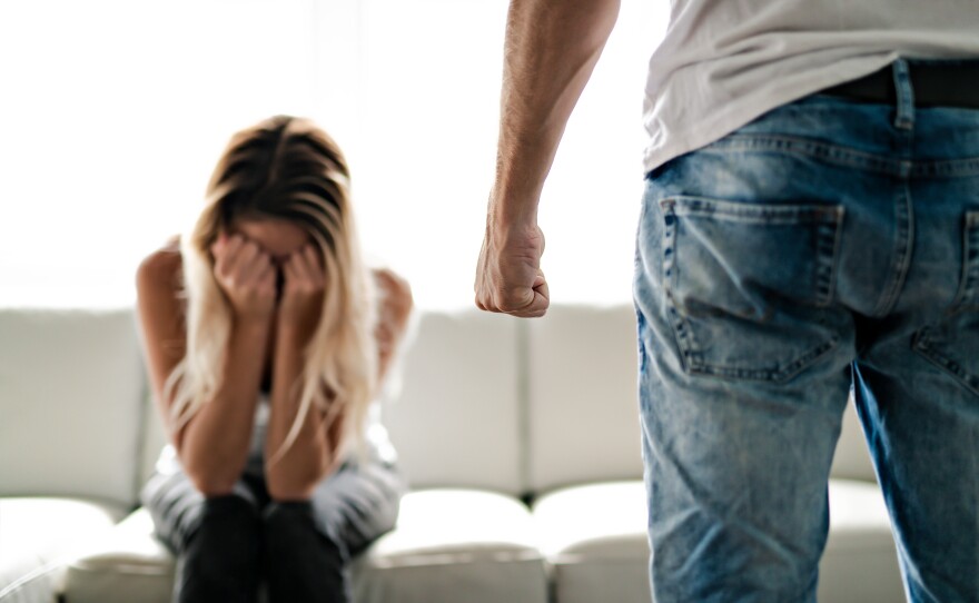 A man beating up his wife illustrates domestic violence.