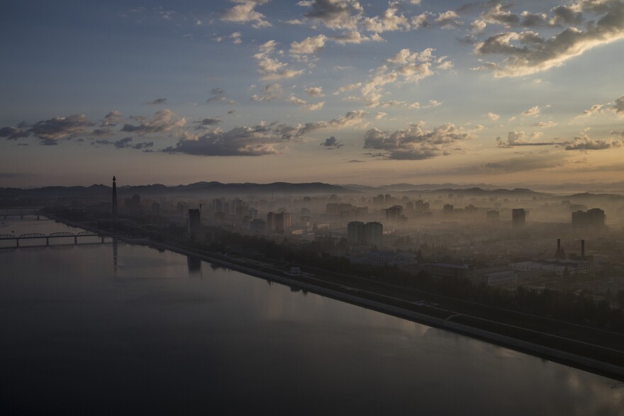 Pyongyang and the Taedong River at dawn, as viewed from the Yanggakdo Hotel. The hotel is located on an island in the middle of the river, isolating it and its guests from the rest of the city. North Korea often houses visitors there, including all of the foreign journalists covering the 70th-anniversary celebrations.