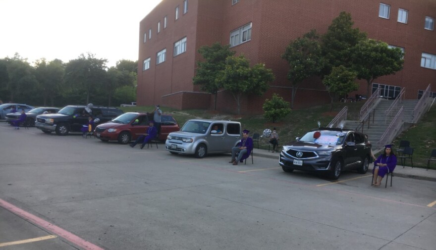 Emmett Conrad High's Collegiate Academy graduates kept a safe distance in the school's back parking lot, as arranged by school staff.