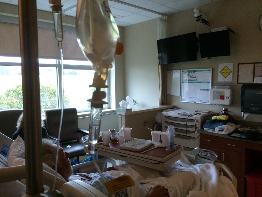 One of the screens in Richard Gilbert's hospital room is a TV. The other is an eICU screen, which lets him see and converse with an extra nurse who checks on his care.