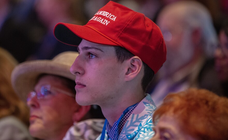 A young supporter in the crowd wears a "Make America Great Again" hat. Donald Trump's 2016 campaign slogan is the clear message of the CPAC.