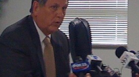 Dr. Keith Ballard talks with reporters.
