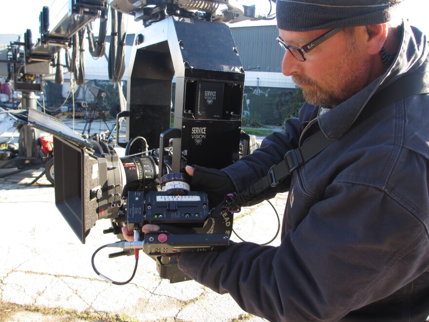 Nielsen's remote device controls focus, zoom and aperture on the camera; a white wheel is marked with numbers that indicate distance. Nielsen assesses the distance between camera and actor, and he needs to be precise: If he sets the wheel to 9 1/2 feet, but the distance is actually only 9 feet 3 inches, the shot will be out of focus.