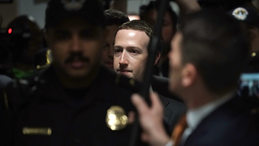 Facebook CEO Mark Zuckerberg is escorted by police on his way to a meeting Monday with U.S. Sen. Dianne Feinstein, D-Calif., ranking member of the Senate Judiciary Committee.