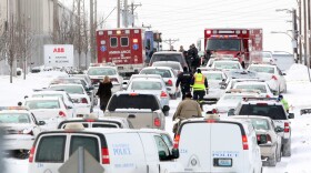 Dozens of law enforcement vehicles line Bircher Boulevard, outside ABB's complex in north St. Louis, on Jan. 7, 2010.