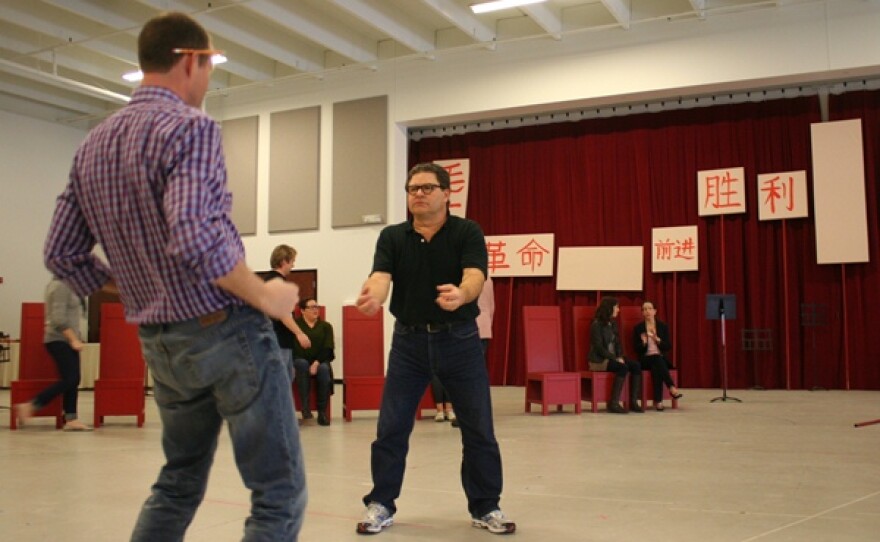Scenes from a rehearsal: Director Michael Cavanagh and Richard Paul Fink (as Kissinger as brutal landlord Lao Szu) demonstrate hip thrusts.