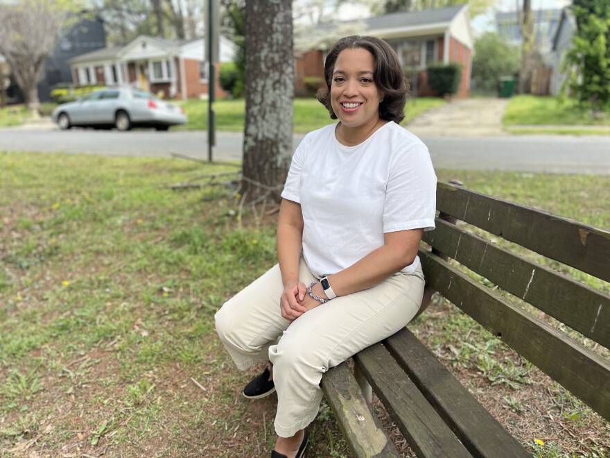 Joi Mayo sits at a bench at Wilmore Neighborhood nearby homes that could be destroyed through the North Carolina Department of Transportation's I-77 expansion plans.