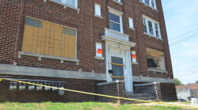 An apartment building is boarded up.