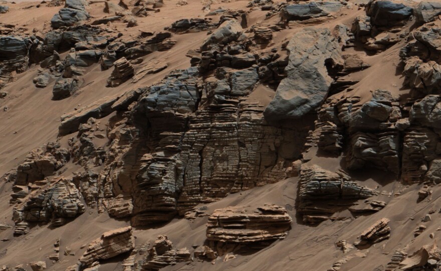 Layers of rock in this image taken at the edge of "Hidden Valley" on Mars suggest "a lake-floor sedimentary deposit not far from where flowing water entered a lake," NASA says.