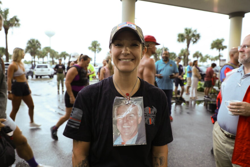 Stephanie Mendez wears a photo of her stepmother's first husband, Martin Wolfworth, who was in the South Tower on Sept. 11, 2001 and died.