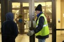 A volunteer welcomes a person into a warming center in Eugene.