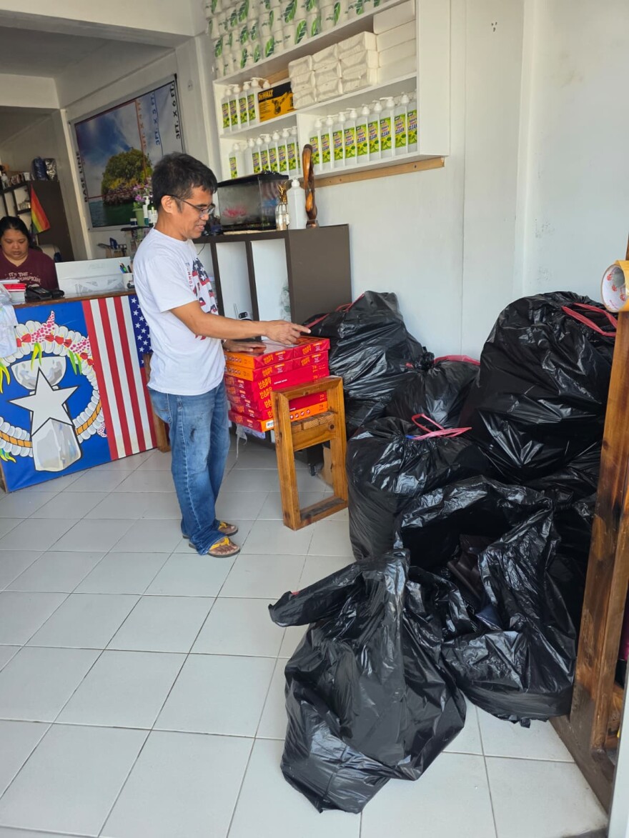Michael Temperante on Monday points to some apparel that got wet from Super Typhoon Sinlaku