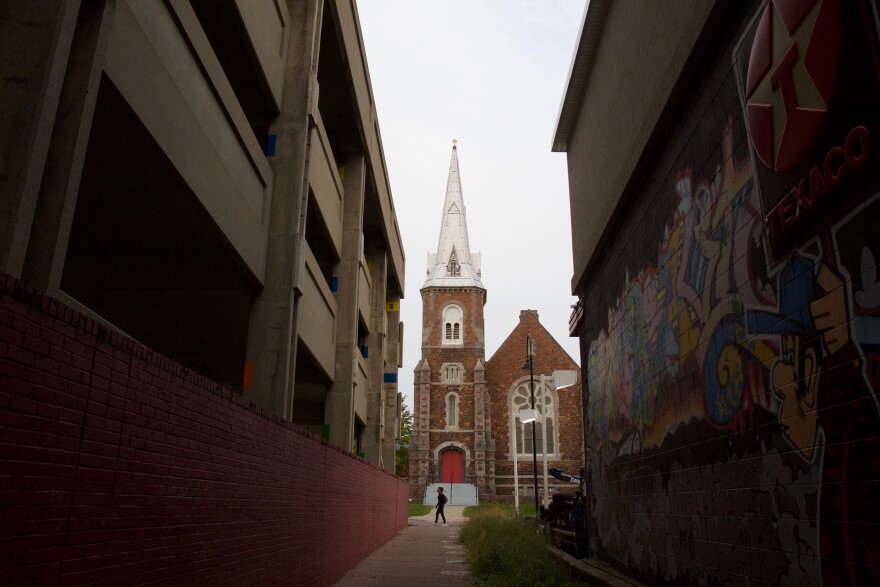 An alley with a church at the end of it. 