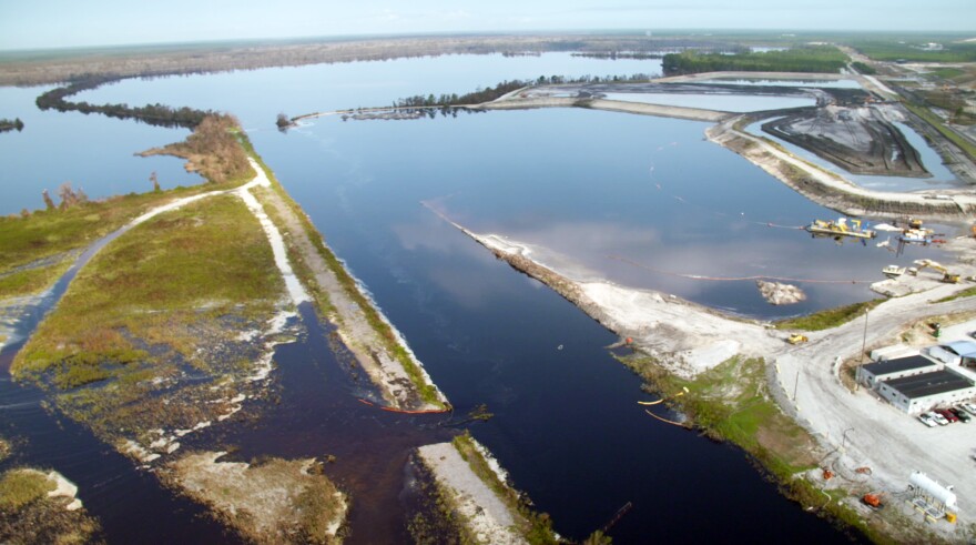 A discharge canal at Duke Energy's Sutton plant flows past a flooded 1971 coal ash basin and into Sutton Lake.  A 1984 ash basin (upper right) has not been flooded, Duke says. 