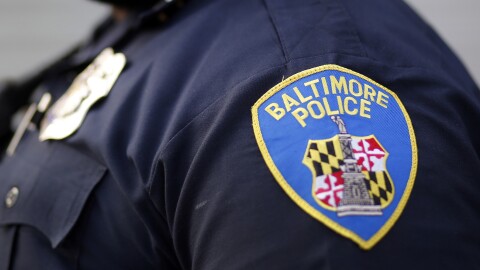 FILE - A shoulder patch is displayed on a Baltimore Police Department officer on March 31, 2016, in Baltimore. Two veteran Baltimore police officers are facing criminal indictments stemming from separate and unrelated allegations, city officials said Thursday, March 16, 2023. One officer is accused of sexual harassment and the other allegedly got drunk and belligerent at a Baltimore bar, assaulted two women and pulled a gun while refusing to pay his tab. (AP Photo/Patrick Semansky, File)