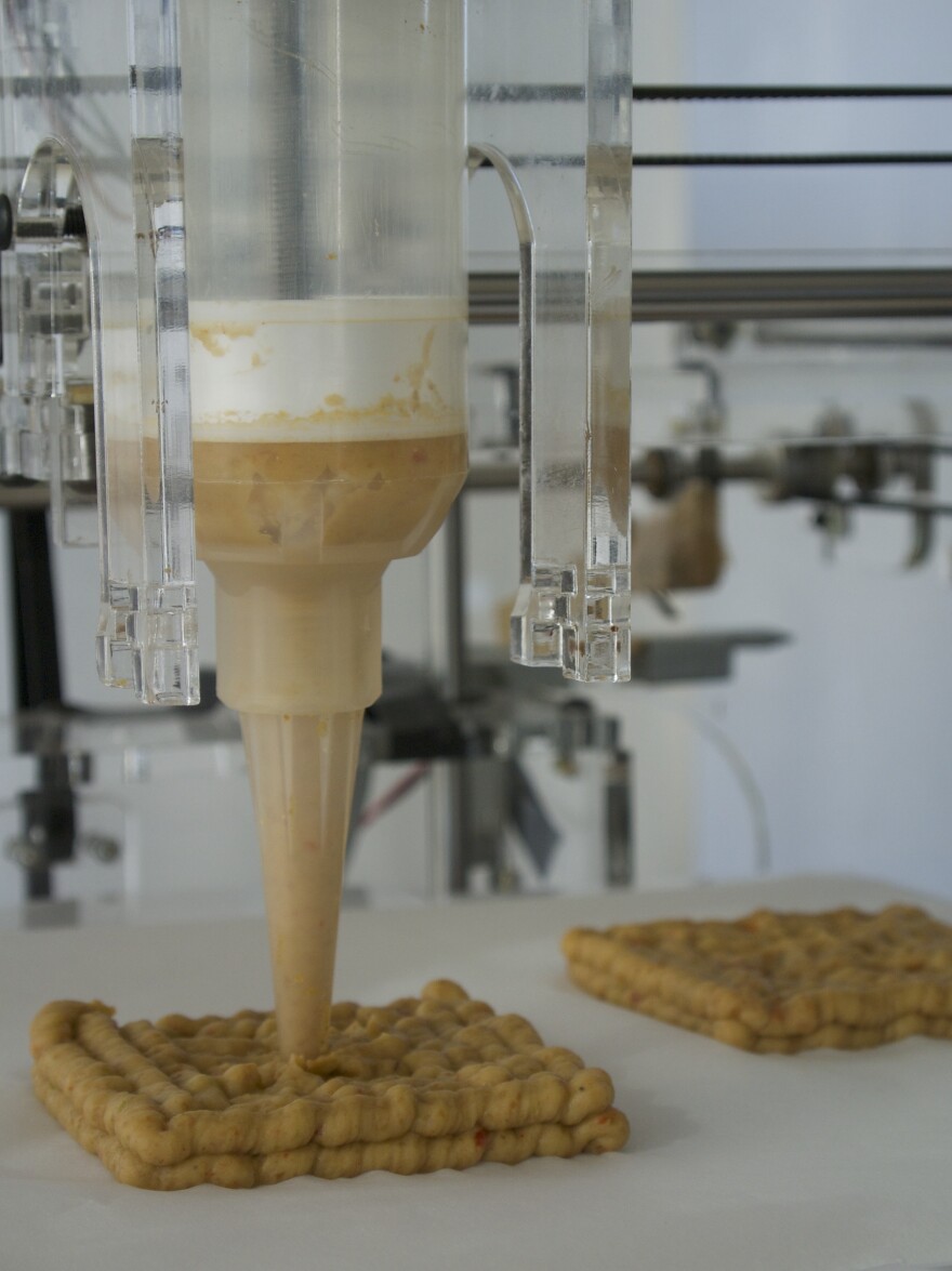 Here, the Foodini prints up the bread for a burger. The 3-D food printer will come with five ports to fill with homemade doughs, sauces or fillings.