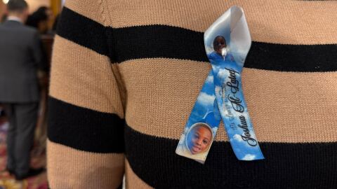 Jonisa Cook wears a ribbon in honor of her son Joshua Al-Lateef Jr.