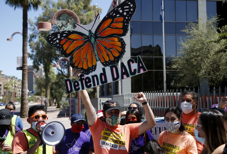 Protesters chant in front of the U.S. Immigration and Customs Enforcement building during a rally after the U.S. Supreme Court ruled on the Deferred Action for Childhood Arrivals program Thursday, June 18, 2020, in Phoenix. The U.S. Supreme Court ruled President Donald Trump improperly ended the program that protects immigrants brought to the country as children and allows them to legally work, keeping the people enrolled in DACA.