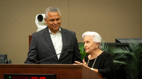Orange County Tourism Development Tax advisory task force co-chair Eddy Moratin, left, listens to co-chair Linda Chapin during the Orange County Commission meeting on Tuesday, Aug. 25, 2026.