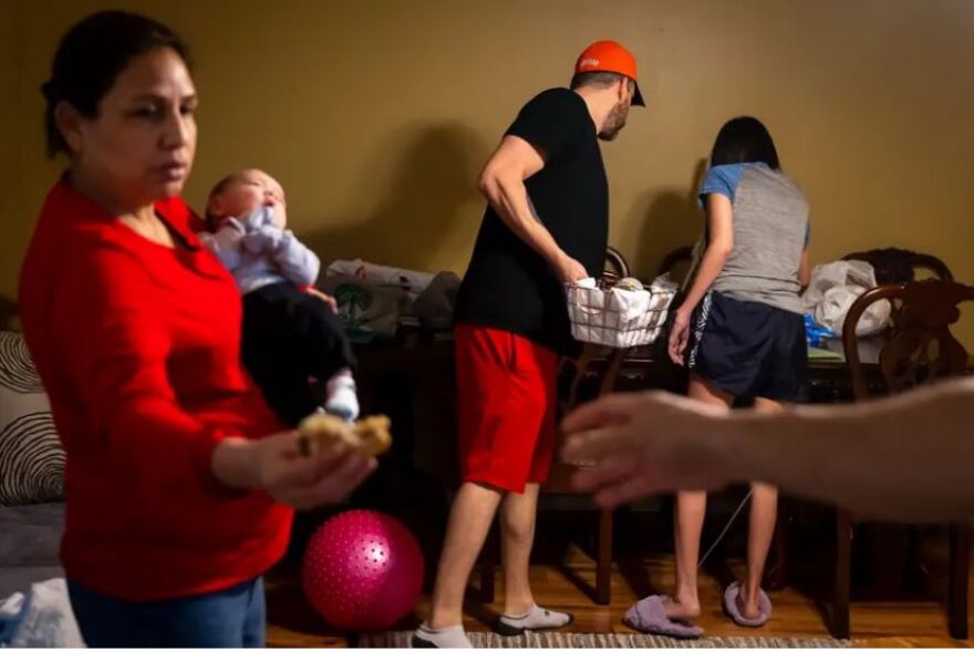 Chris Crouch doles out medications for his wife, Diana, in their home while their baby is held by his grandmother.