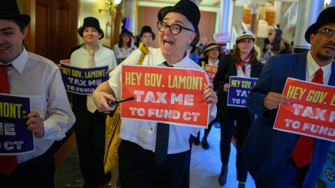 Hartford, Ct. — April 15, 2026 — Protestors dressed as Mr. Monopoly, march through The Capitol on Tax Day, April 15, 2026, to deliver postcards petitioning Governor Lamont to raise taxes on the wealthy.
