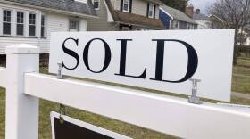 A sold sign hangs in front of a Brighton, New York house. (Ted Shaffrey/AP)