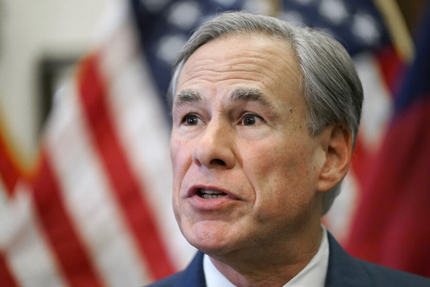 Headshot of Greg Abbott with flag in the background.