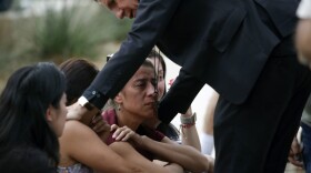 The archbishop of San Antonio, Gustavo Garcia-Siller, comforts families outside the Civic Center following a deadly school shooting at Robb Elementary School in Uvalde, Texas, Tuesday, May 24, 2022. 