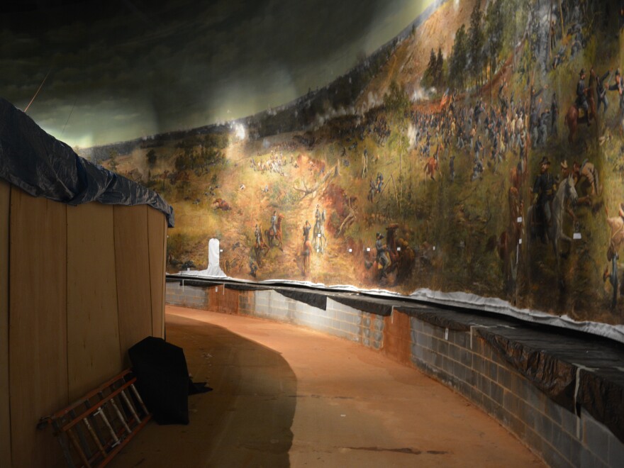 The view of the painting from where one stood a diorama featuring models of soldiers.