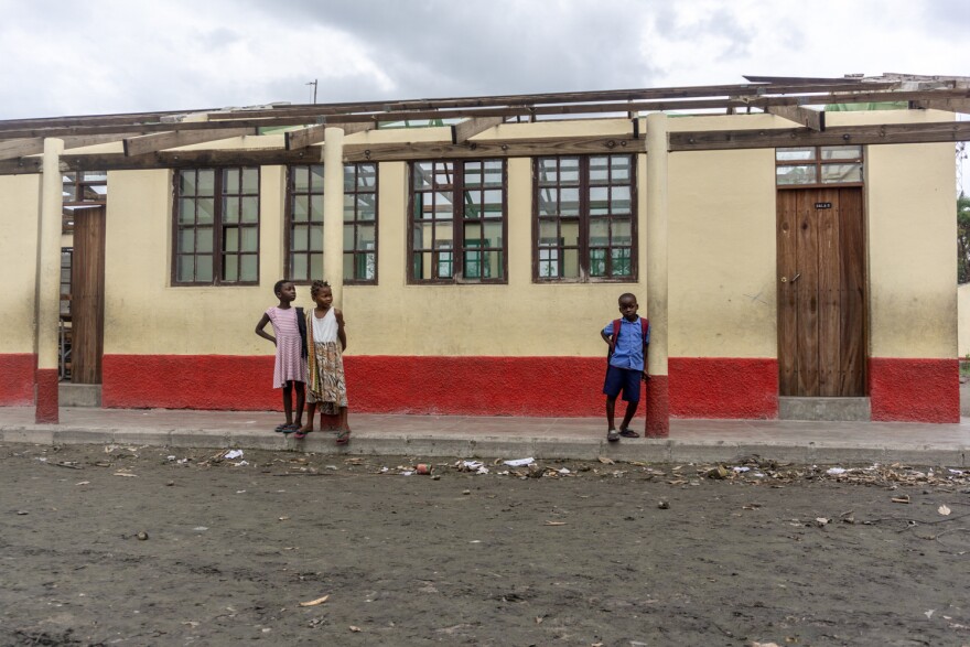 Students at the Eduardo Mondlane school stand next to classrooms destroyed by Cyclone Idai.