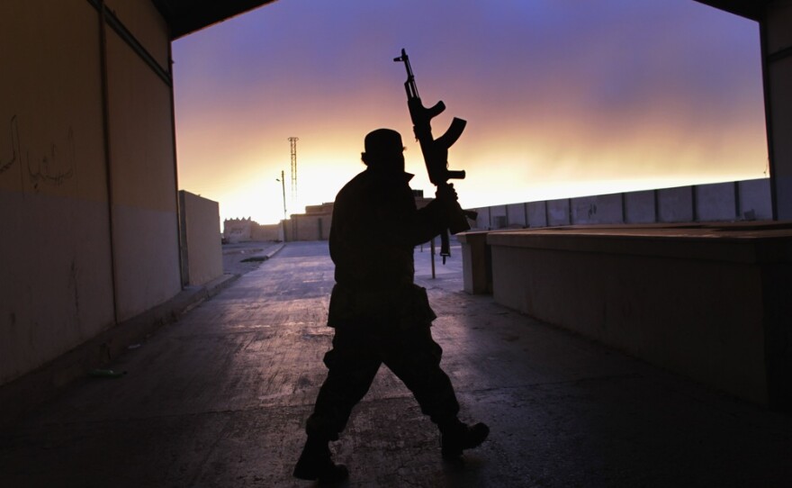 A Libyan border guard walks through an empty customs hall on the Libya-Egypt border on Thursday.