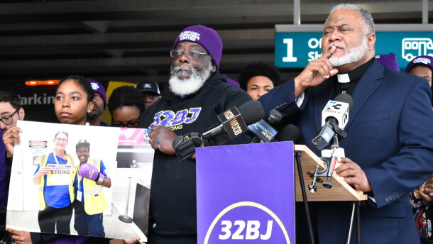 Rev. Dr. Rodney Sadler, representative-elect for N.C. House District 106, stands with airport union workers during a vigil for ABM employee Colleen Coates.