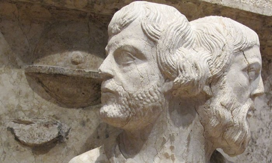 The ancient Roman God Janus, with two heads. The one looking toward the new year appears young, whereas the one facing what has been appears aged. Museum of Ferrara Cathedral, Italy.