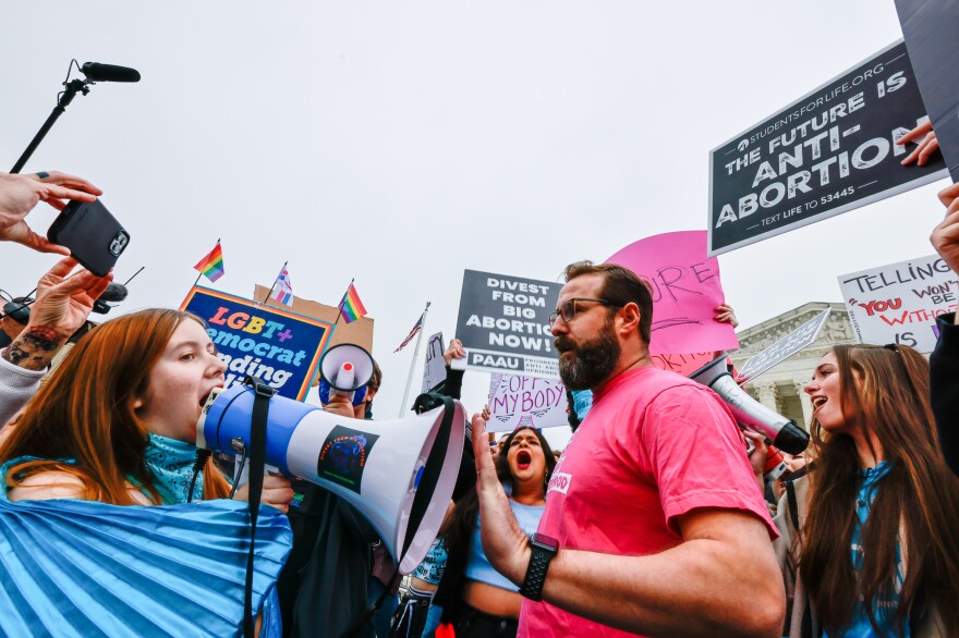 Abortion-rights activist argues with anti-abortion-rights protesters outside the U.S. Supreme Court.