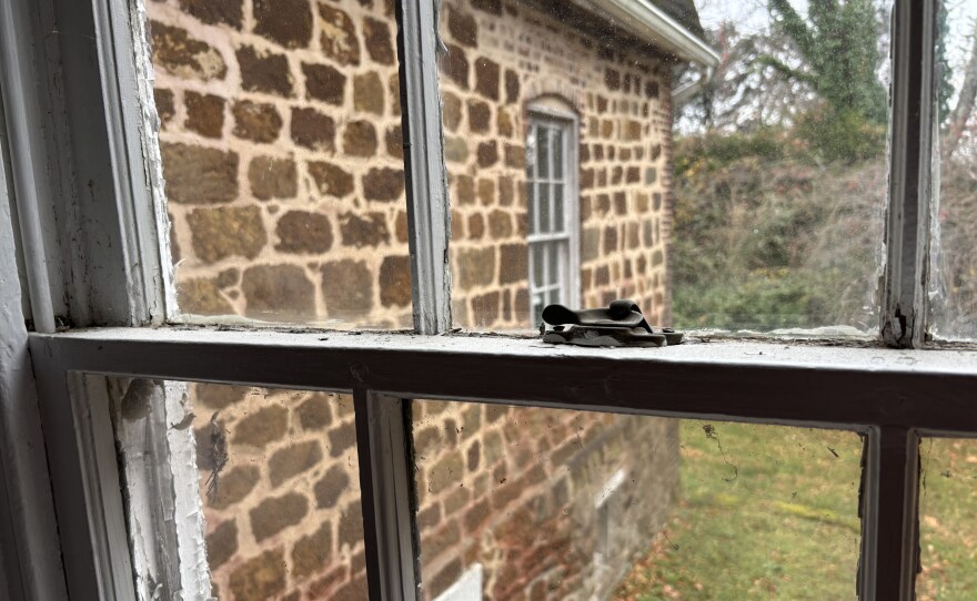 Original 1736 stone house seen through a window at Belvoir.