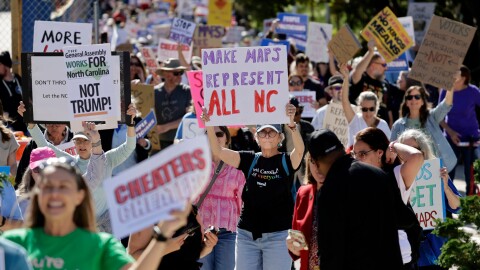Marchers proceed from the Capitol during a rally protesting a proposed redistricting map Tuesday, Oct. 21, 2025, in Raleigh, N.C.