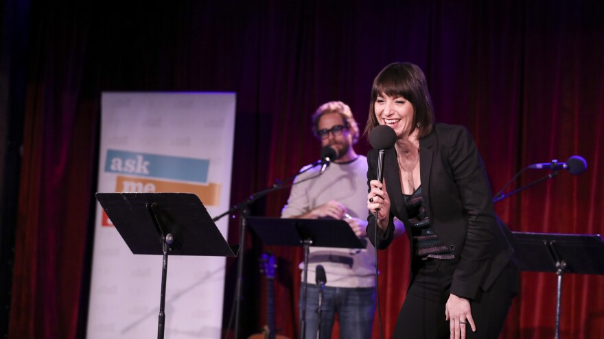 Ophira Eisenberg performs on stage on Ask Me Another at the Bell House in Brooklyn, New York.
