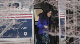 A passenger disembarks the Amtrak Downeaster, Wednesday, March 8, 2023, in Portland, Maine.
