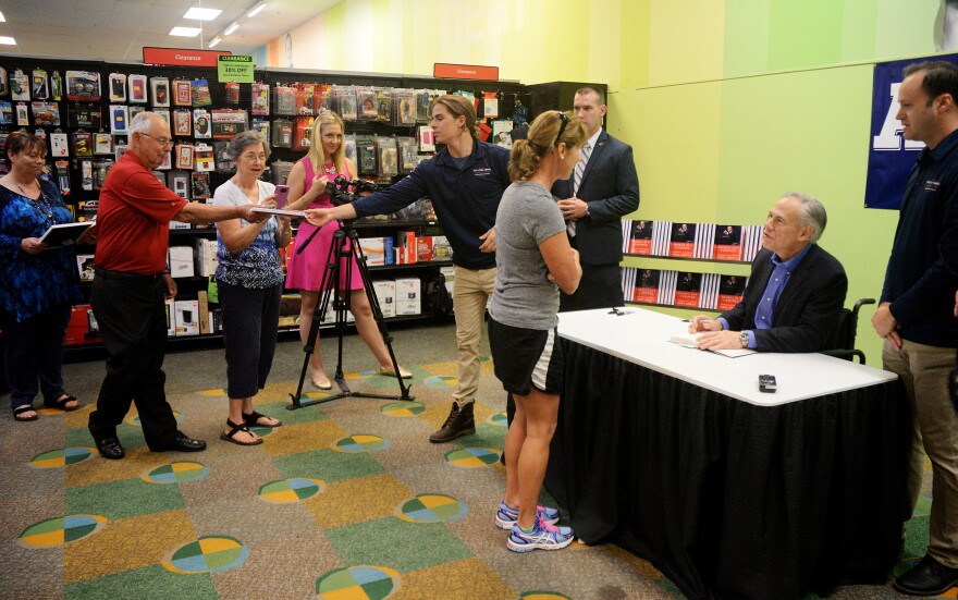 (Photo by Joy Bonala) Donna Draper meets Texas Governor Greg Abbott during his book signing tour Monday, May 23, 2016 at Hastings Entertainment. 