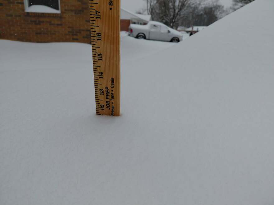 A ruler shows nearly a foot of snow at a home in central Kettering as of Sunday afternoon.