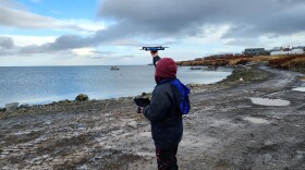 Photo by Mike DeLue Pilot Katie Daniels, with the Association of Village Council Presidents, launches a Skydio drone over the community of Mertarvik on Oct. 20, 2022.