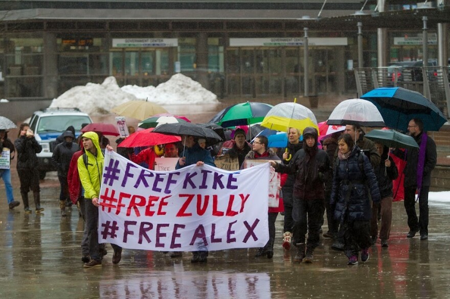 Protesters from Vermont and Massachusetts carry a sign with the name of the three activists, Enrique "Kike" Balcazar, Zully Palacios and Alex Carillo-Sanchez, outside the court house in Boston, March 2017.