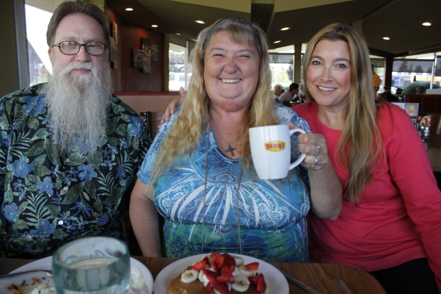 Sandra Anderson enjoys a celebratory meal at one of her favorite restaurants with Kevin Krause and Ravenna Candy from the nonprofit, Navos. Anderson is graduating from Navos' housing program - her apartment will be signed over to her name.