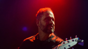 Charlie Hunter playing a guitar.