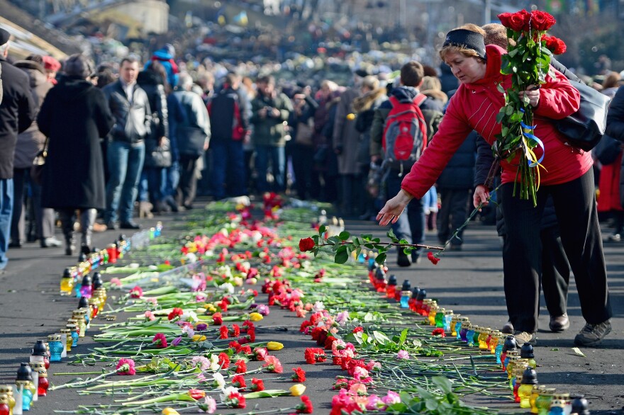 In Kiev's Independence Square, flowers have been left in memory of protesters killed there in recent days.