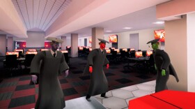 Screengrab from the video game showing avatars in graduation caps and gowns