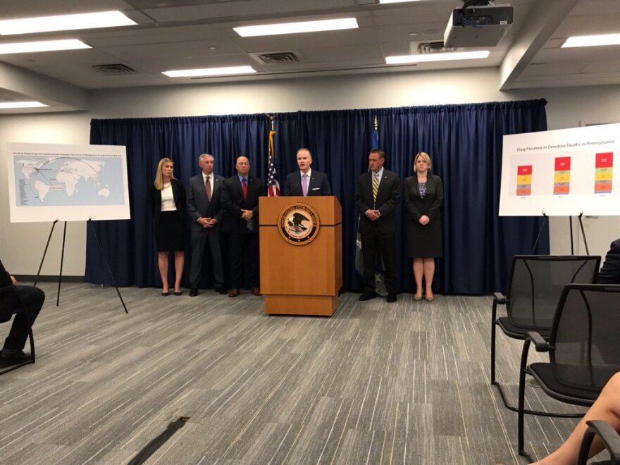 William McSwain, center, at Tuesday's presser. 