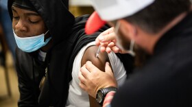 Kevin Parish receives a COVID-19 vaccine in his left arm.