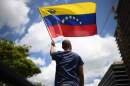 A man waves a Venezuelan flag during a protest in Caracas on August 17, 2024. (Federico Parra/AFP via Getty Images)